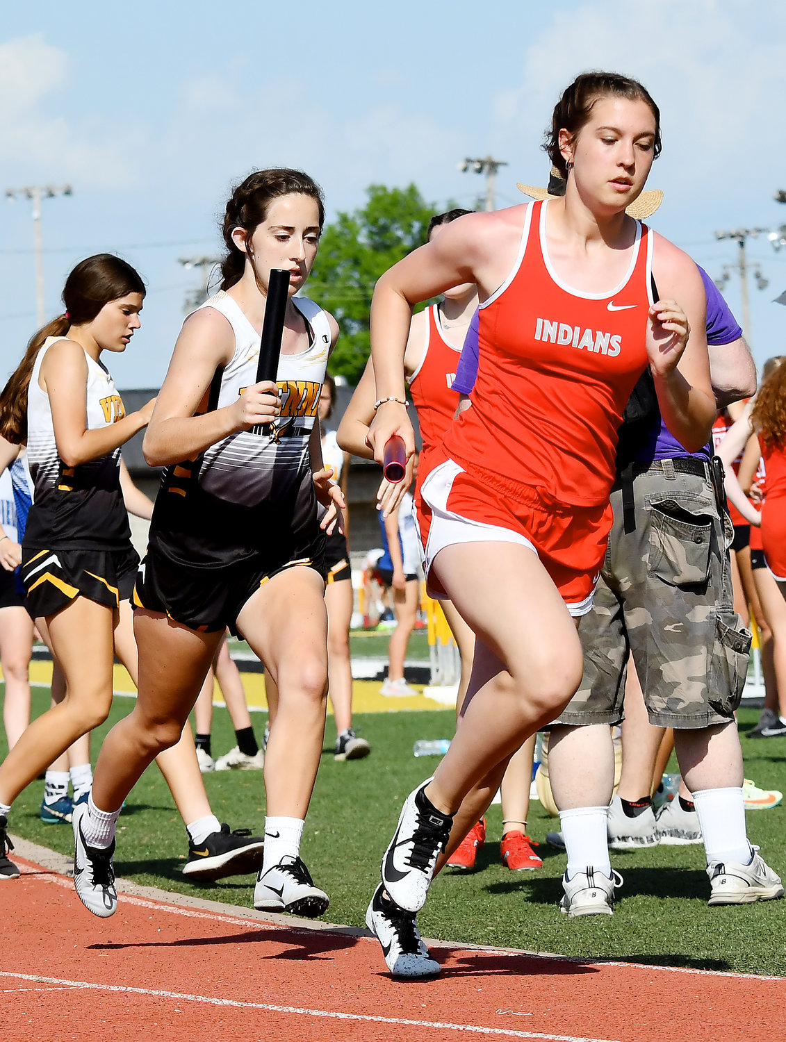 Jaedyn Schell (center) takes off with the baton after getting in from Aubrey Reeves for Vienna’s Lady Eagles in the girls 4x400-meter relay at Monroe City High School. Schell and Reeves helped Vienna place fourth in the race allowing them to advance to state along with Rosentreter.